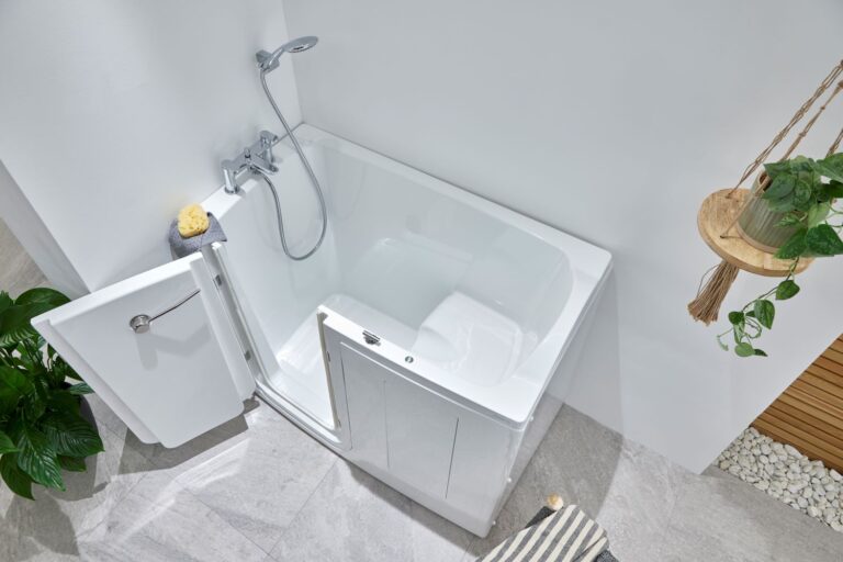 Overhead view of a deep soak walk-in bath with a built-in seat and detachable shower head, designed for easy access and comfort.